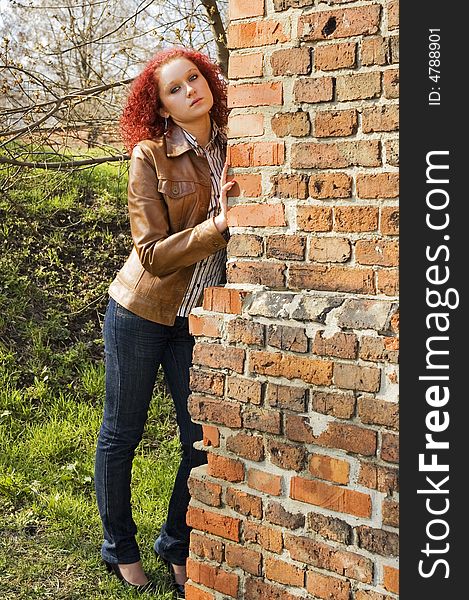 Young women look out of wall