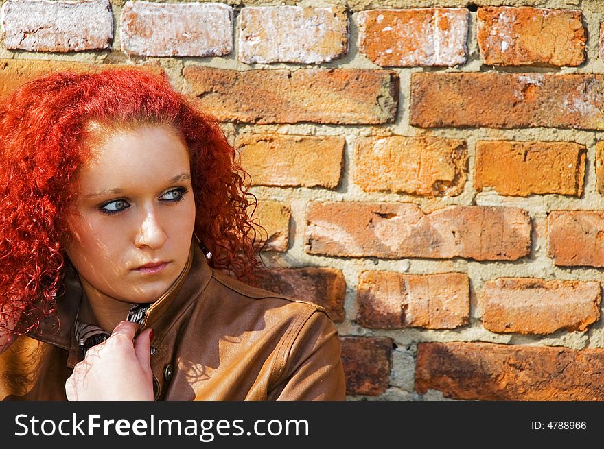 Beautiful young women over bricked wall