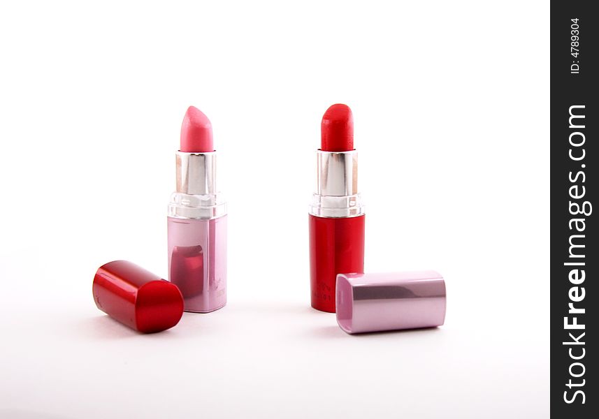 Vivid red lipstick and ping lipstick on white background
