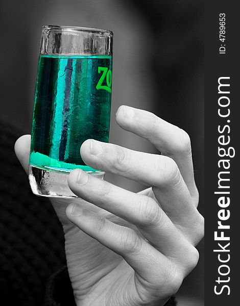 An image aof a hand taking a glass with a green drink