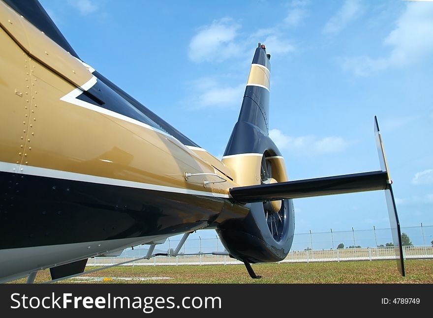 Tail of black and gold coloured helicopter. Tail of black and gold coloured helicopter