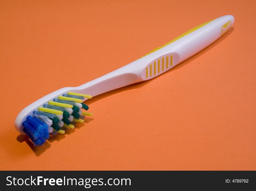 Tooth brush on an orange background