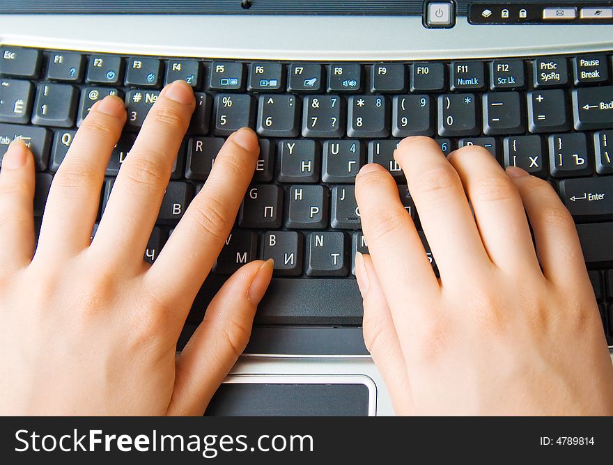 Human hands typing on the keyboard