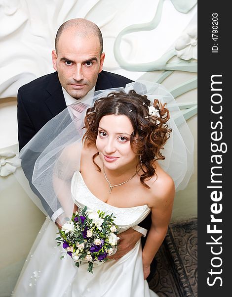 Just married young couple in wedding wear with bridal bouquet. Special toned photo f/x