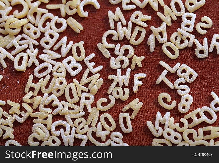 Eatable mini alphabet on table, background