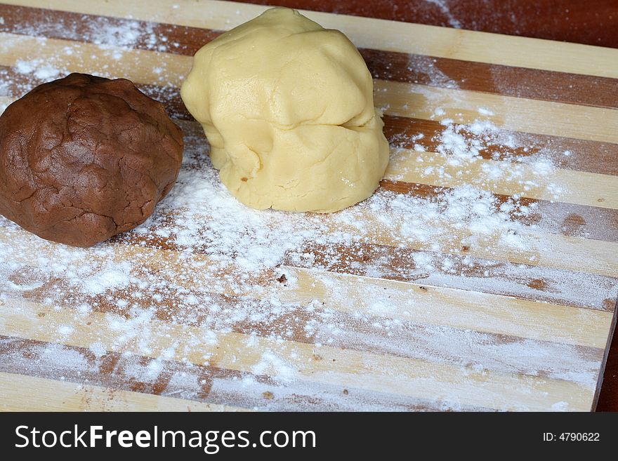 Chocolate and vanilla dough on a board, 2