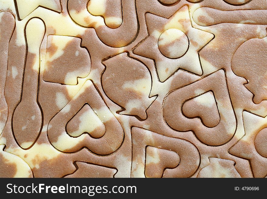 Various figures on a chocolate dough, food background