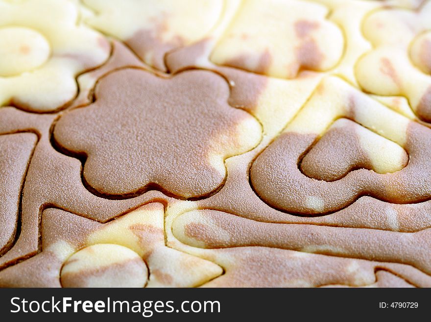 Various figures on a chocolate dough, food background