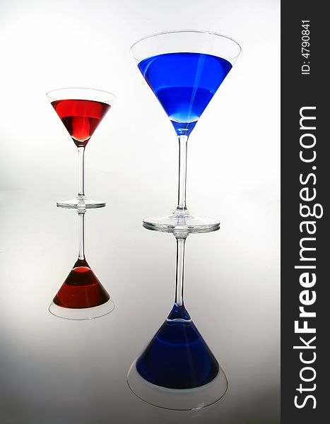 Red and blue coctail are standing on the table. Red and blue coctail are standing on the table
