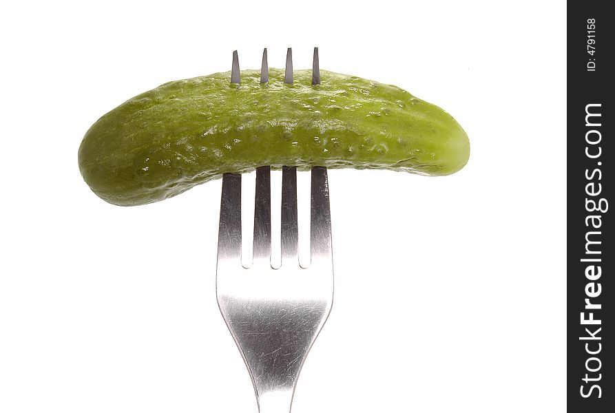 Salted cucumber on fork isolated on white background