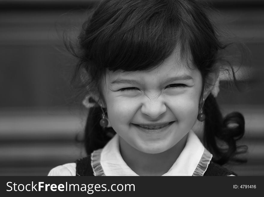 Smiling girl with ponytails on the black-white photo