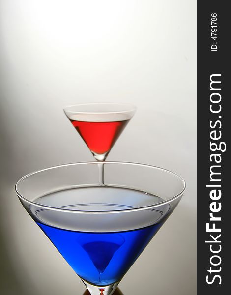 Macro shot of a blue coctail with red behind. Macro shot of a blue coctail with red behind