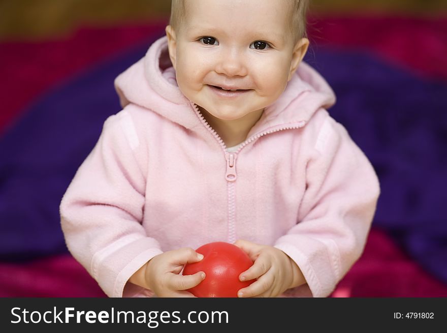 Girl with small ball on violet background