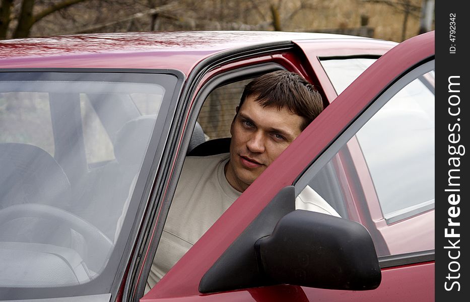 Young person with red car. Young person with red car