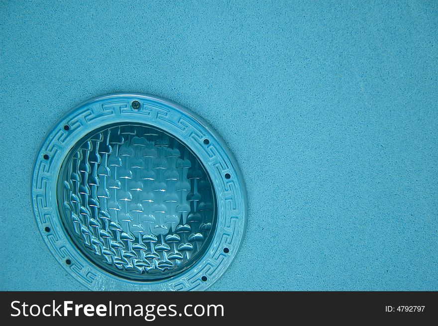 Underwater swimming pool light in blue colored water