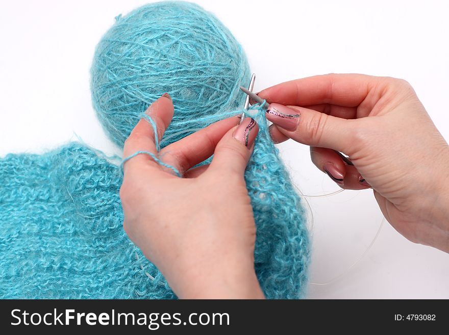 Woman hands knitting a turquoise pullover. Woman hands knitting a turquoise pullover