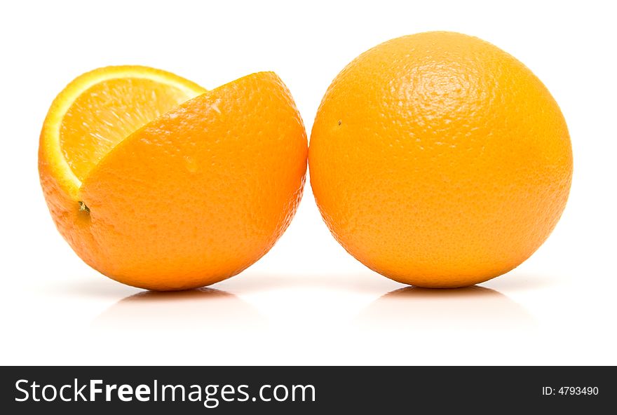 Fresh wet oranges on white. Isolation, shallow DOF.