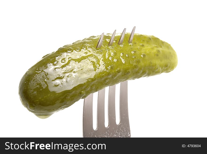 Salted cucumber on fork isolated on white background