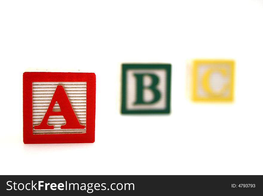 Three wood alphabet blocks with the letters a b and c. Three wood alphabet blocks with the letters a b and c