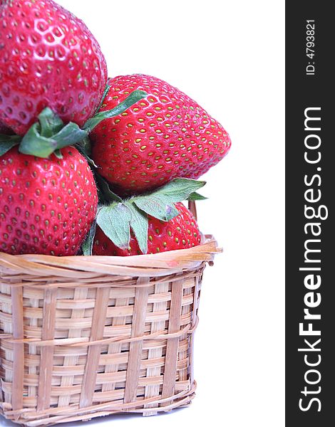 Small basket of strawberries on white