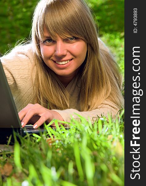 Beautiful young girl with laptop outdoor portrait