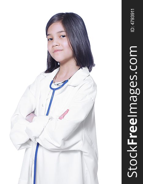 Nine year old girl playing doctor with white lab coat and stethoscope. Nine year old girl playing doctor with white lab coat and stethoscope