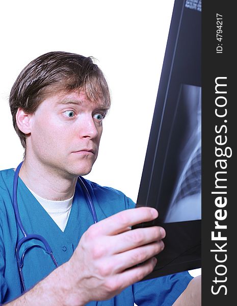 Male doctor looking with humorous shock at x ray. Male doctor looking with humorous shock at x ray