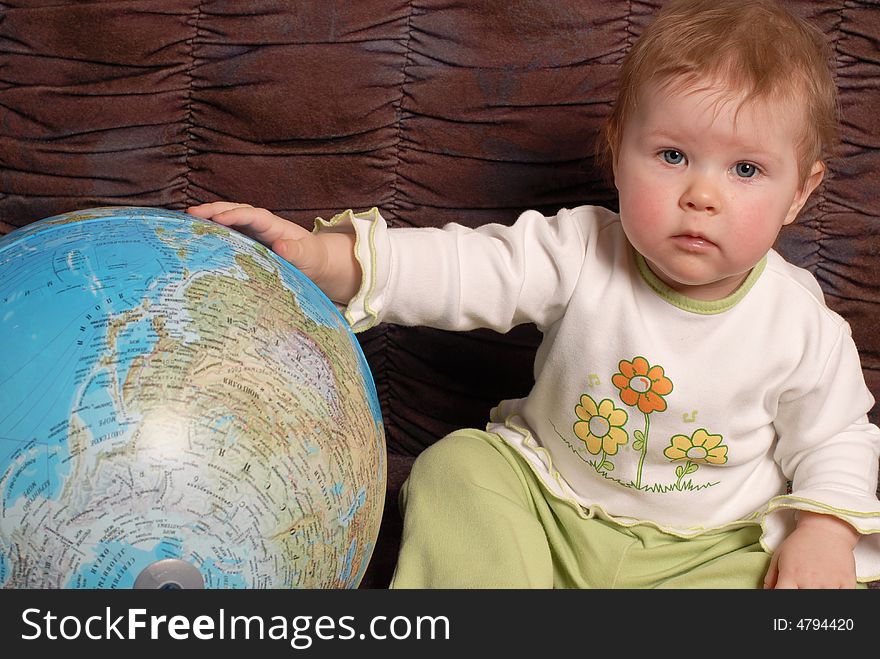 Portrait of the little girl on a brown background