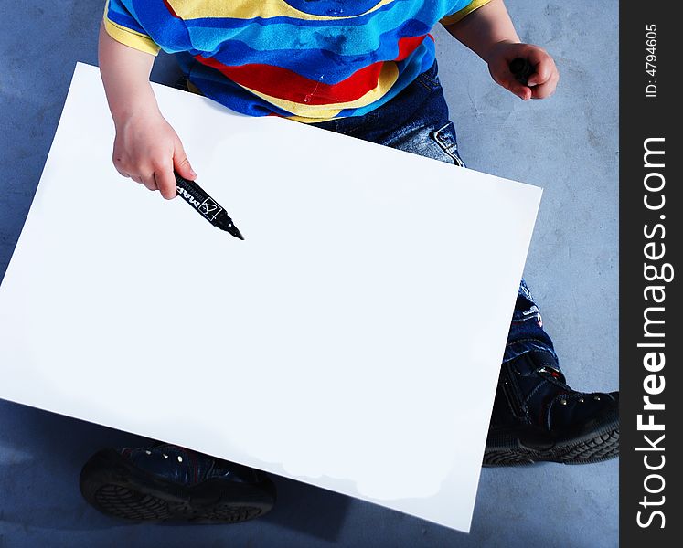 Child with white paper at blue background