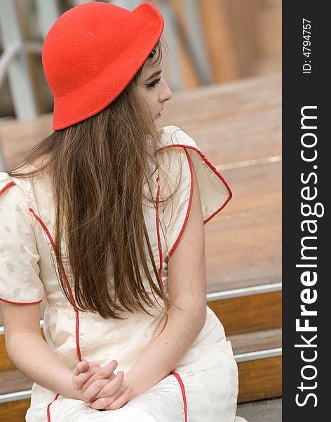 The young beautiful girl in a red cap