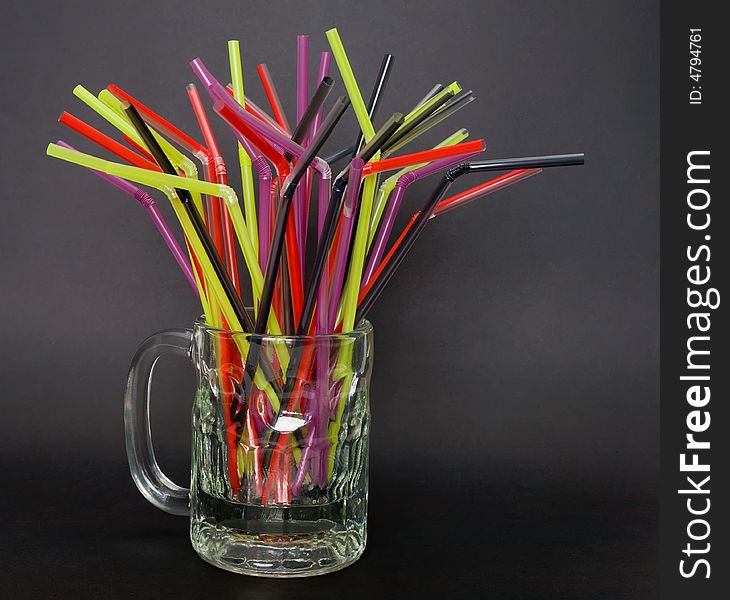 A bunch of colorful straws in a mug. A bunch of colorful straws in a mug