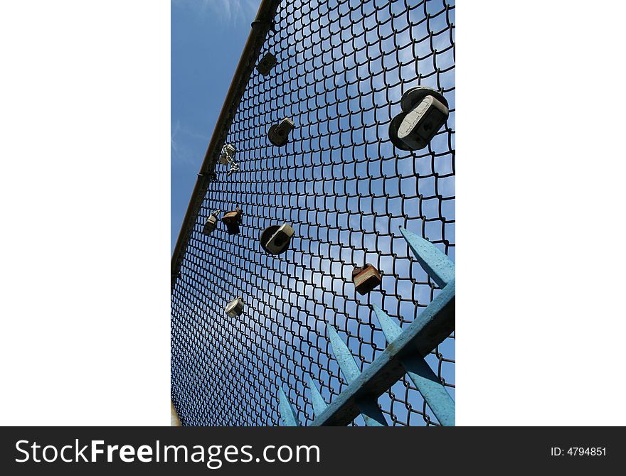 Padlocks on a wire mesh, sign of  love that binds two teenagers