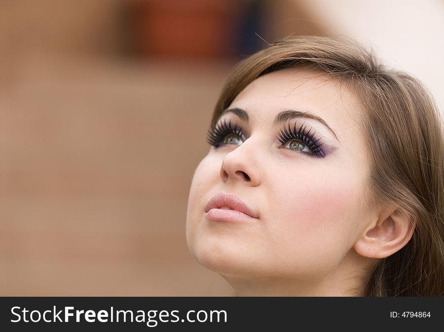 Sight of the young beautiful woman at a brown background