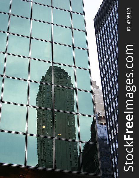Particular of a Skyscraper in Manhattan (New York), showing a lot of windows in a geometric drawing. Particular of a Skyscraper in Manhattan (New York), showing a lot of windows in a geometric drawing