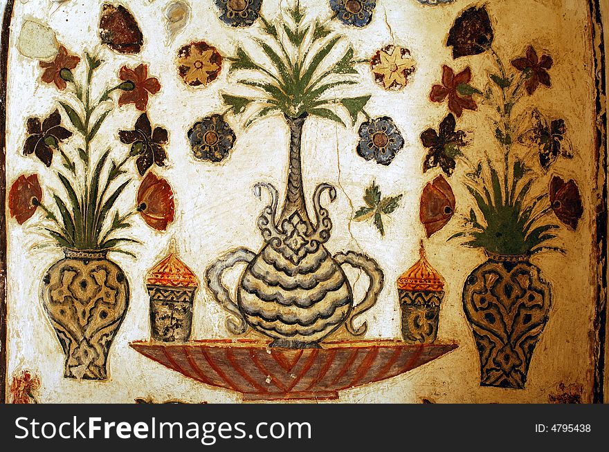 India, Agra: old painting on a wall of a mausoleum; symmetry and flowers design in persian style. India, Agra: old painting on a wall of a mausoleum; symmetry and flowers design in persian style