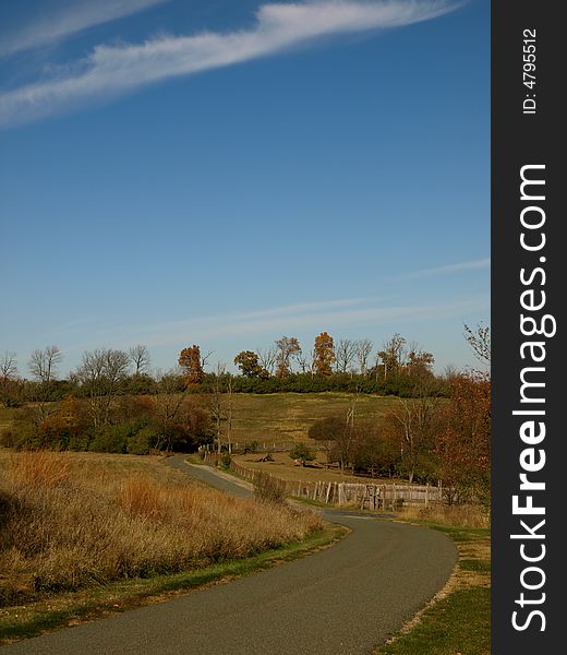 Winding country road with blue sky and fall foliage