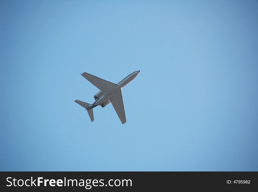 An aeroplane in the blue sky. An aeroplane in the blue sky