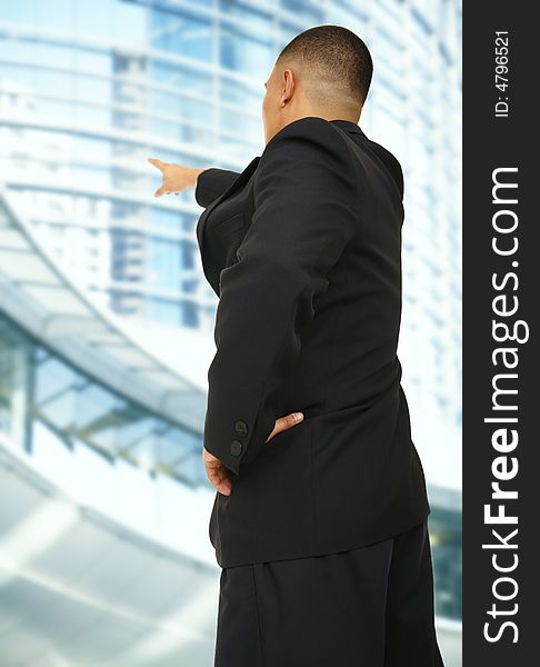 A business man pointing at modern building outdoor in downtown area. A business man pointing at modern building outdoor in downtown area