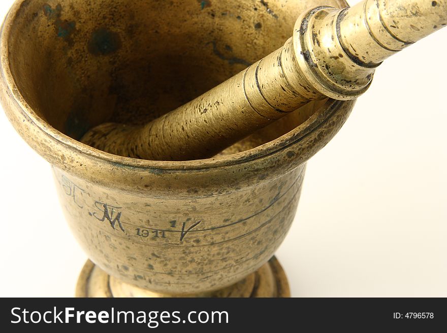 Ancient bronze mortar with pestle on white background, close up view
