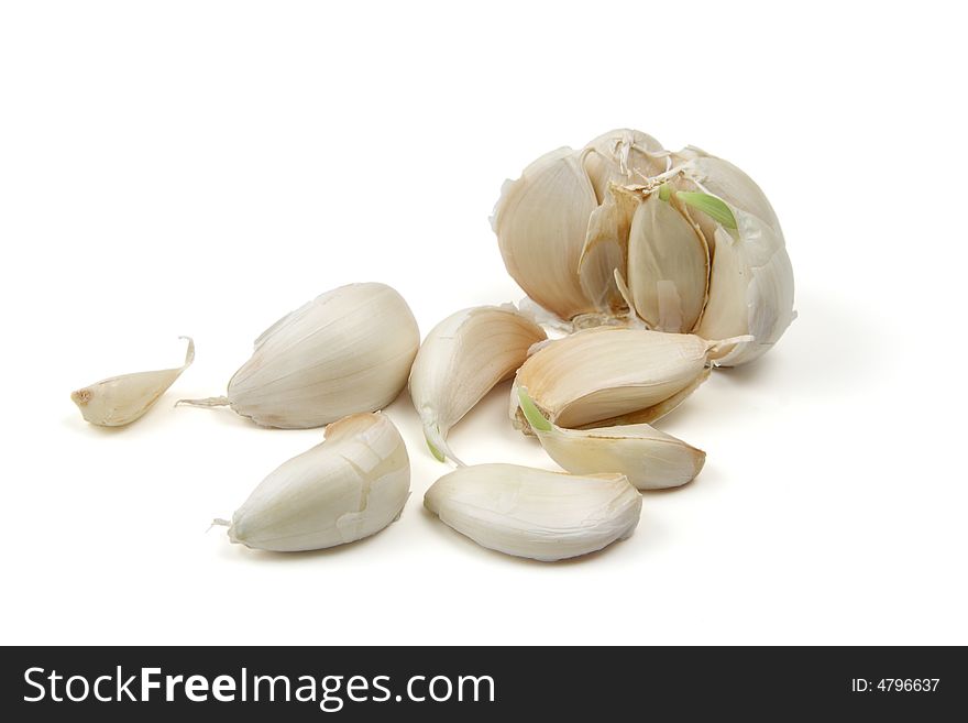 Broken bulb of garlic with cloves isolated on white background
