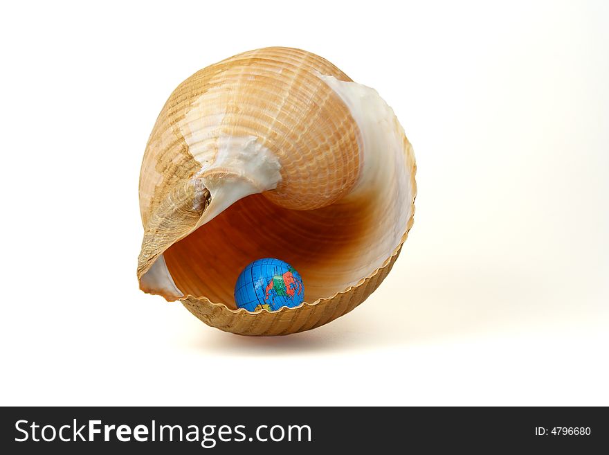 Isolated sea shell and little globe isolated on white background. Isolated sea shell and little globe isolated on white background