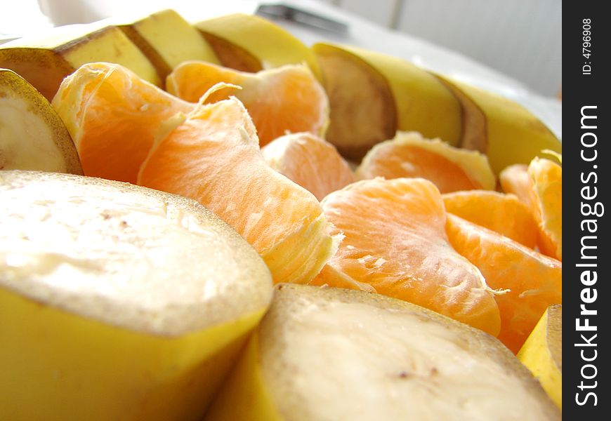 Different kind of fresh fruits bananas and mandarines