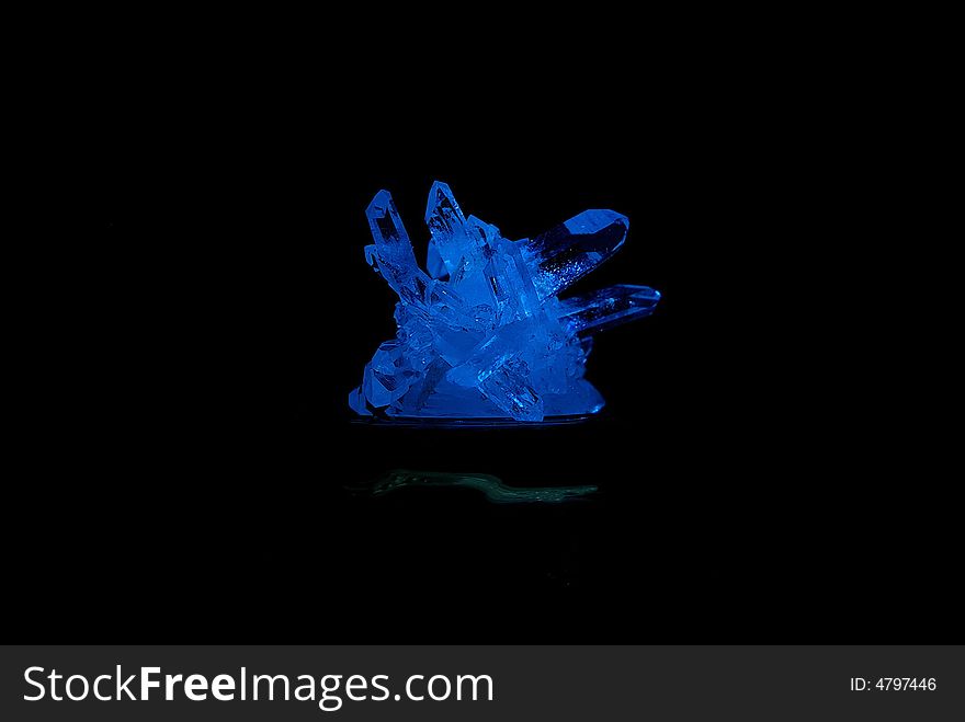 Gift a Blue crystal of a mineral, on a black background