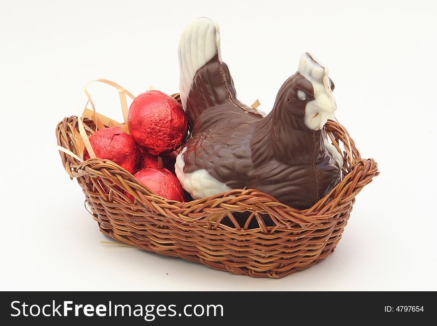 Easter Chicken with chocolate Egs on a white/grey background