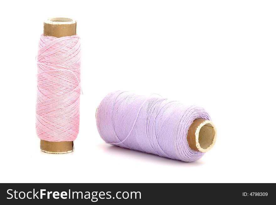 Bobbins of thread isolated in background white