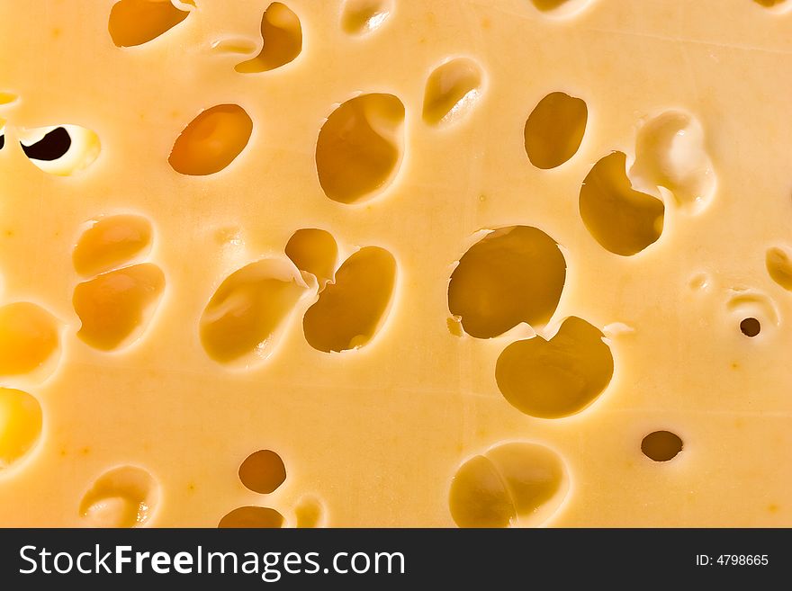 Macro picture of a cheese loaf with holes. Macro picture of a cheese loaf with holes