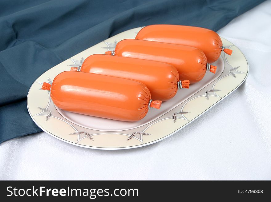 Ready boiled sausage on a plate