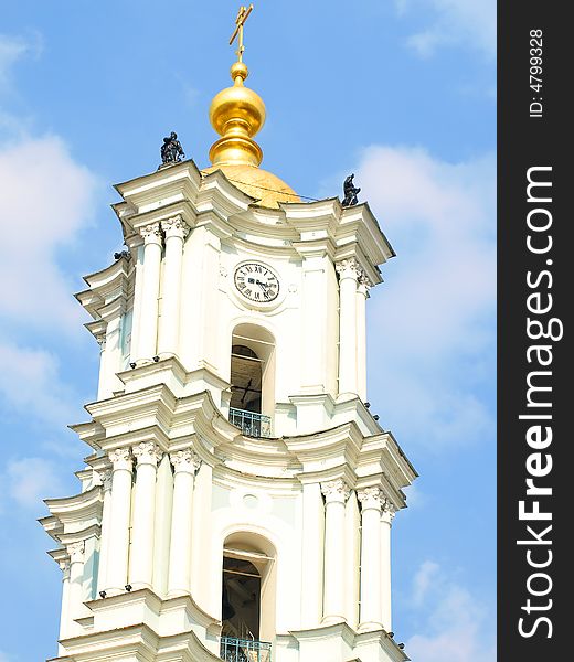 Tall white church tower with the golden dome