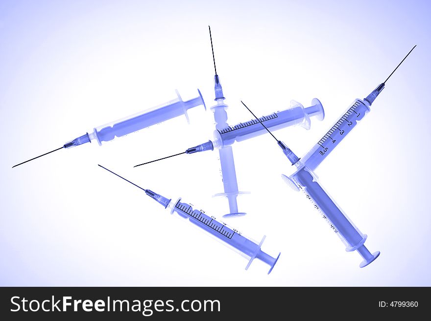 Plastic disposable syringes, toned in blue color.