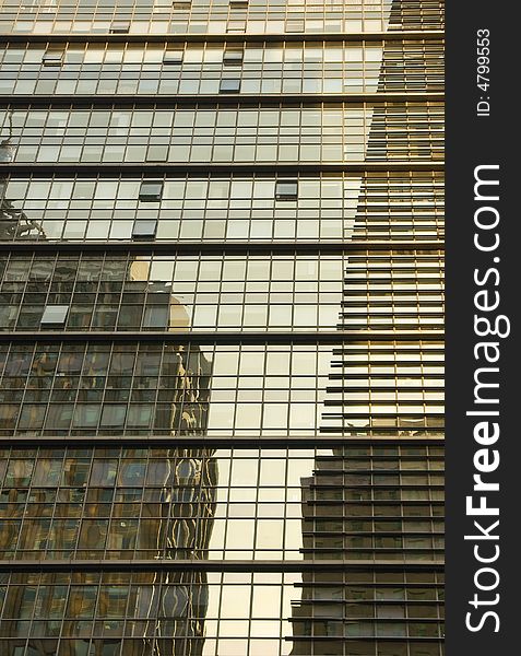 Reflections of two office buildings in a modern building
in Beijing. Reflections of two office buildings in a modern building
in Beijing.